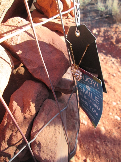 Necklace on tag on cairn